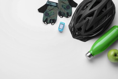 Flat lay composition with different cycling accessories on white background, space for text