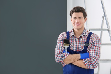 Portrait of male decorator with brush indoors