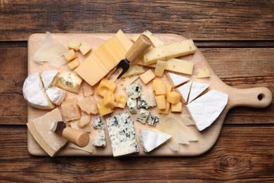 Cheese plate on wooden table, top view
