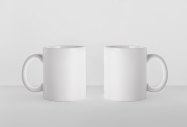 Blank ceramic mugs on white background. Mockup for design