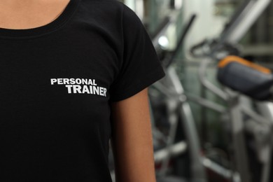Personal trainer in modern gym, closeup view