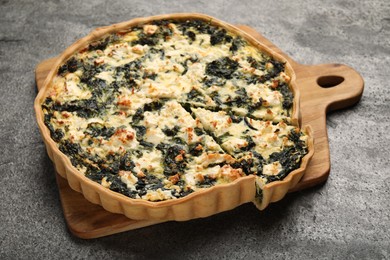 Photo of Delicious homemade spinach quiche on gray table