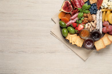 Different tasty appetizers on wooden table, top view. Space for text