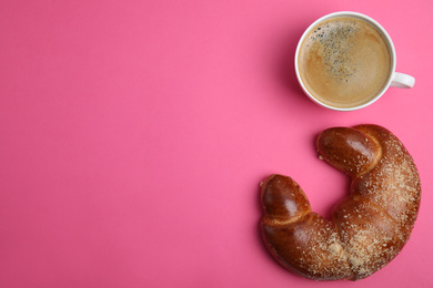 Delicious coffee and pastry on pink background, flat lay. Space for text
