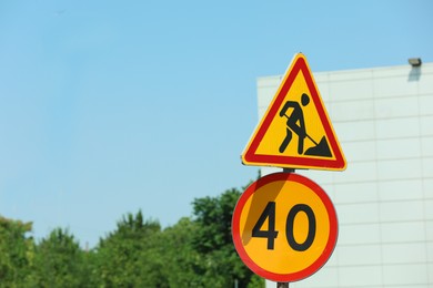 Road construction and speed limit signs outdoors on sunny day. Repair works