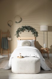 Stylish bedroom decorated with beautiful eucalyptus garland