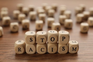 Cubes with phrase Stop Racism on wooden table