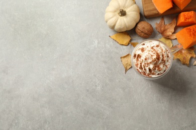 Delicious pumpkin latte on light grey table, flat lay. Space for text