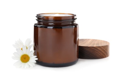 Jar of hand cream and chamomiles on white background