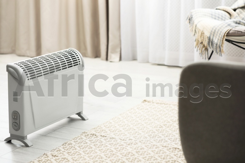 Image of Modern electric heater in stylish room interior