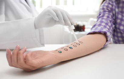Photo of Patient undergoing skin allergy test at light table, closeup