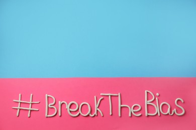 Hashtag BreakTheBias made of modeling clay on color background, top view. Space for text