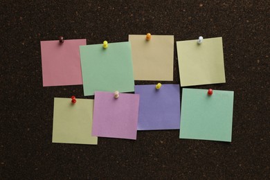 Colorful paper notes pinned to cork board