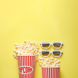 Flat lay composition with delicious popcorn on yellow background