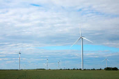 Beautiful view of field with wind turbines. Alternative energy source