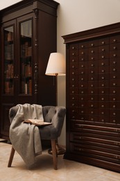 Library interior with wooden furniture and comfortable place for reading