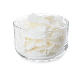 Wax flakes in glass bowl on white background. Homemade candle material