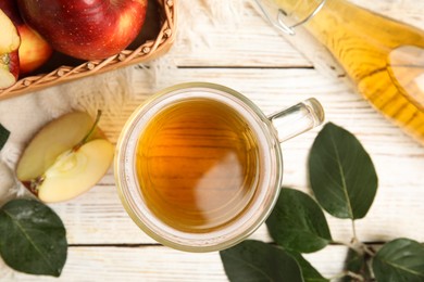 Flat lay composition with delicious apple cider on white wooden table