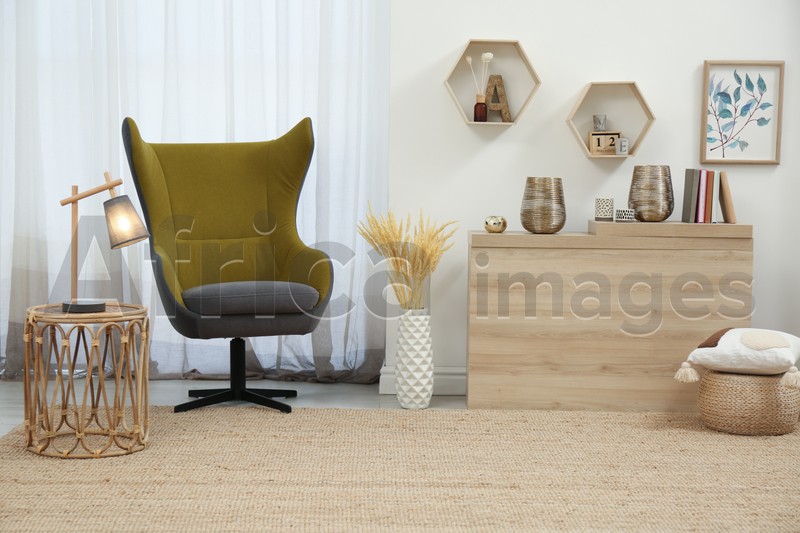 Photo of Stylish living room interior with comfortable armchair and wooden table