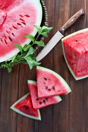 Flat lay composition with tasty ripe watermelon on wooden table