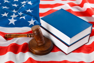 Judge's gavel and books on American flag