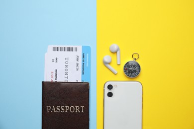 Flat lay composition with passport, tickets and travel items on color background