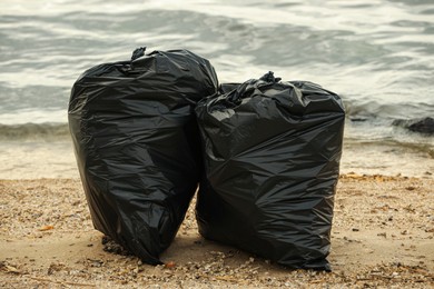 Trash bags full of garbage on beach