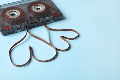 Music cassette and hearts made with tape on light blue background. Listening love song