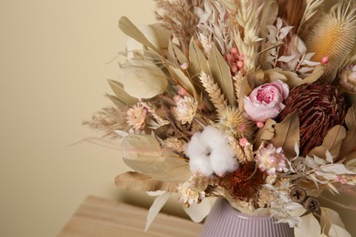 Beautiful dried flower bouquet in vase on table, closeup