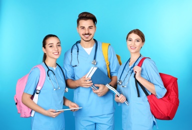 Group of young medical students on color background