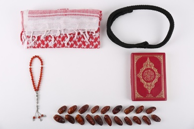 Flat lay composition with Muslim prayer beads, Quran and space for text on white background