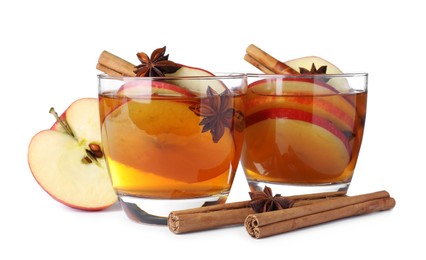 Hot mulled cider and ingredients on white background