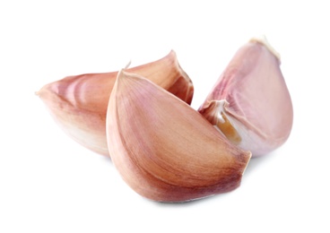 Fresh unpeeled garlic cloves on white background