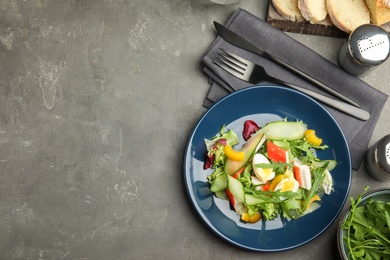 Delicious salad with crab sticks and lettuce on grey table, flat lay. Space for text