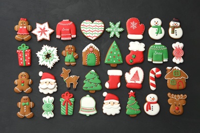 Many different delicious Christmas cookies on black table, flat lay