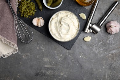 Tasty tartar sauce and ingredients on grey table, flat lay. Space for text
