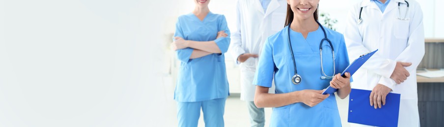 Doctor in uniform with stethoscope at workplace, space for text. Banner design
