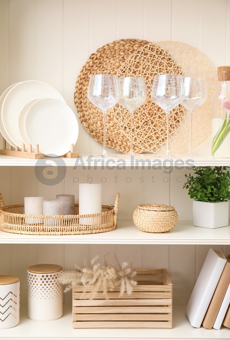 White shelving unit with dishware and different decorative stuff