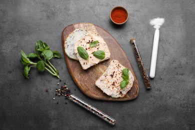 Flat lay composition with sandwiches, various spices and test tubes on grey background