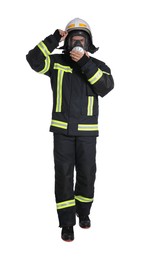 Full length portrait of firefighter in uniform, helmet and gas mask on white background