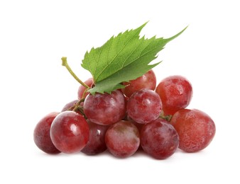 Cluster of ripe red grapes with green leaf on white background