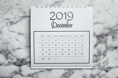 December 2019 calendar on marble background, top view