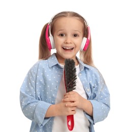 Cute little girl in headphones with brush singing on white background
