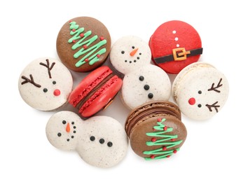 Beautifully decorated Christmas macarons on white background, top view