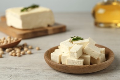 Pieces of delicious tofu with rosemary and soy on white table. Space for text