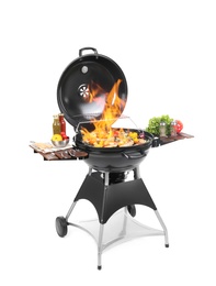 Flaming barbecue grill with cooking meal on white background