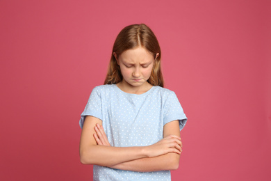Portrait of emotional preteen girl on pink background