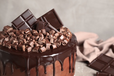 Freshly made delicious chocolate cake against grey background, closeup