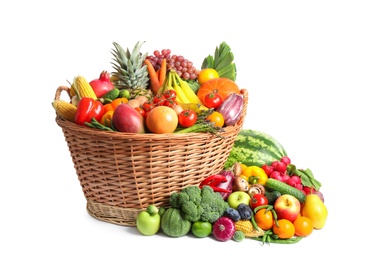 Basket with assortment of fresh organic fruits and vegetables on white background
