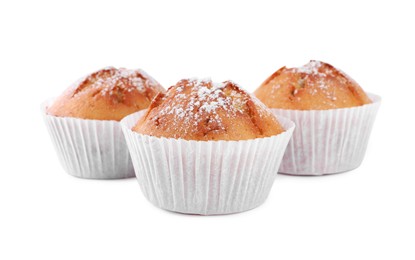 Photo of Tasty muffins powdered with sugar on white background